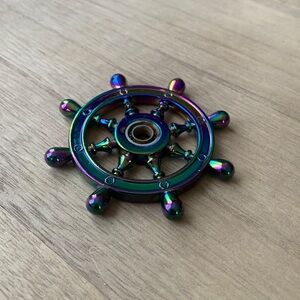 Stainless steel rainbow colored captains wheel.